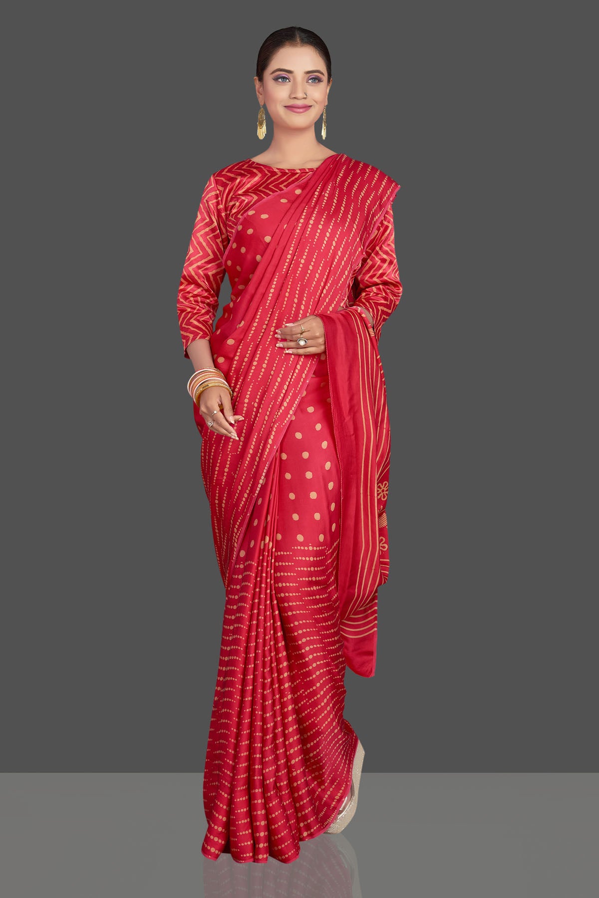 Buy gorgeous red printed modal silk sari online in USA. Make your presence felt on special occasions in beautiful embroidered sarees, handwoven sarees, pure silk sarees, tussar sarees from Pure Elegance Indian saree store in USA.-front