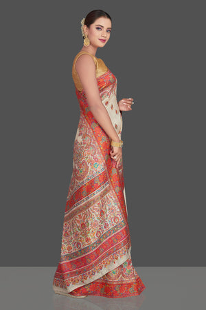Shop stunning cream tussar muga silk saree online in USA with Kani weave. Make your presence felt on special occasions in beautiful embroidered sarees, handwoven saris, pure silk saris, tussar sarees from Pure Elegance Indian saree store in USA.-right