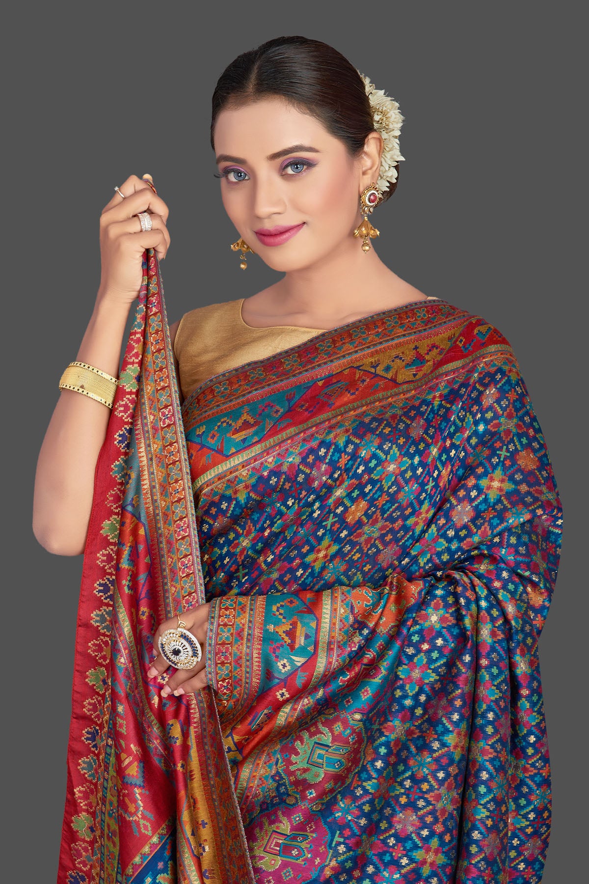 Buy gorgeous blue tussar muga silk saree online in USA with multicolor Kani weave. Make your presence felt on special occasions in beautiful embroidered sarees, handwoven saris, pure silk saris, tussar sarees from Pure Elegance Indian saree store in USA.-closeup