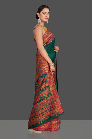 Shop stunning dark green Kani weave tussar muga sari online in USA. Shop designer sarees, printed sarees, embroidered sarees, crepe sarees in USA from Pure Elegance Indian fashion store in USA.-right