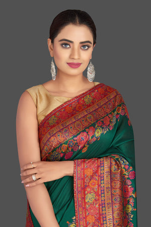 Shop stunning dark green Kani weave tussar muga sari online in USA. Shop designer sarees, printed sarees, embroidered sarees, crepe sarees in USA from Pure Elegance Indian fashion store in USA.-closeup