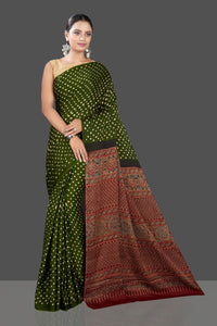 Buy gorgeous green Bandhej print modal silk sari online in USA with red Ajrakh pallu. Look beautiful at weddings and parties with exquisite designer sarees, handwoven saris, pure silk sarees, embroidered sarees, printed sarees from Pure Elegance Indian fashion boutique in USA.-full view
