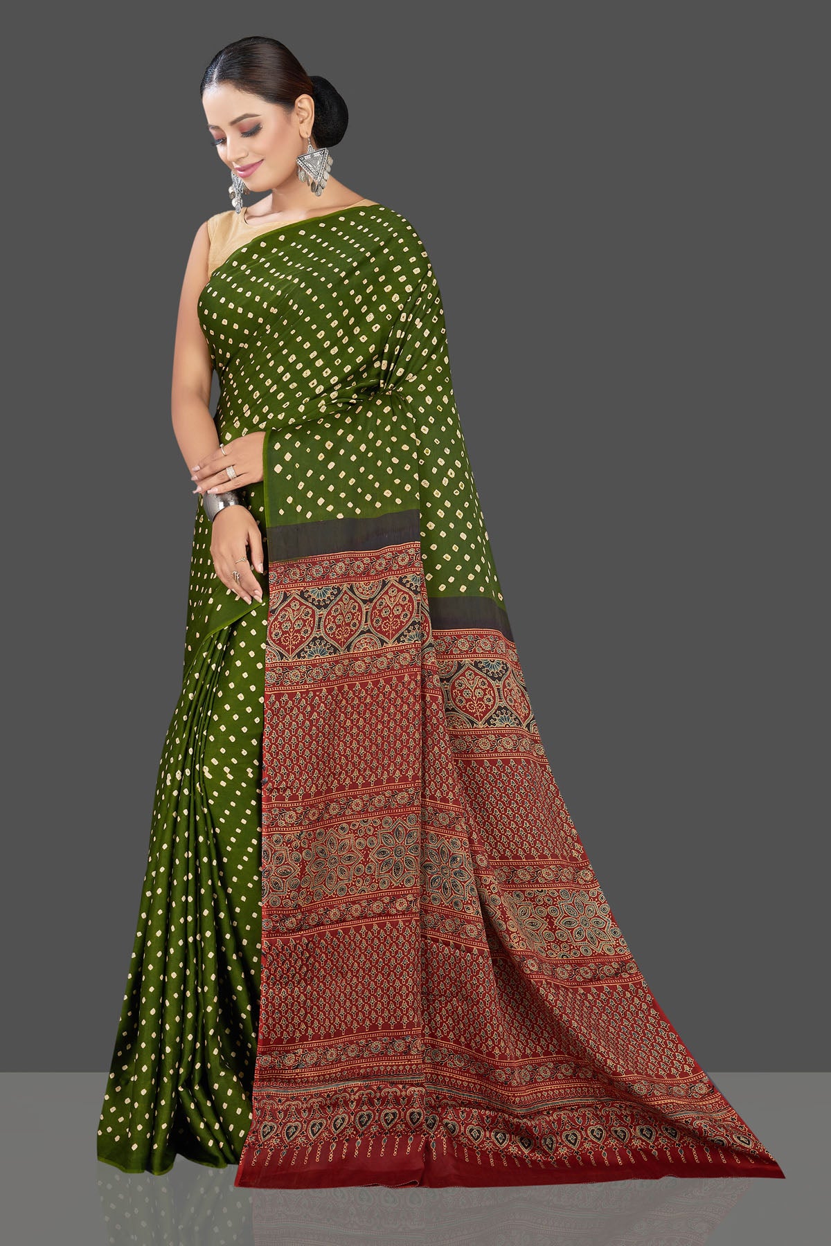 Buy gorgeous green Bandhej print modal silk sari online in USA with red Ajrakh pallu. Look beautiful at weddings and parties with exquisite designer sarees, handwoven saris, pure silk sarees, embroidered sarees, printed sarees from Pure Elegance Indian fashion boutique in USA.-side