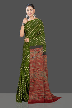 Buy gorgeous green Bandhej print modal silk sari online in USA with red Ajrakh pallu. Look beautiful at weddings and parties with exquisite designer sarees, handwoven saris, pure silk sarees, embroidered sarees, printed sarees from Pure Elegance Indian fashion boutique in USA.-left