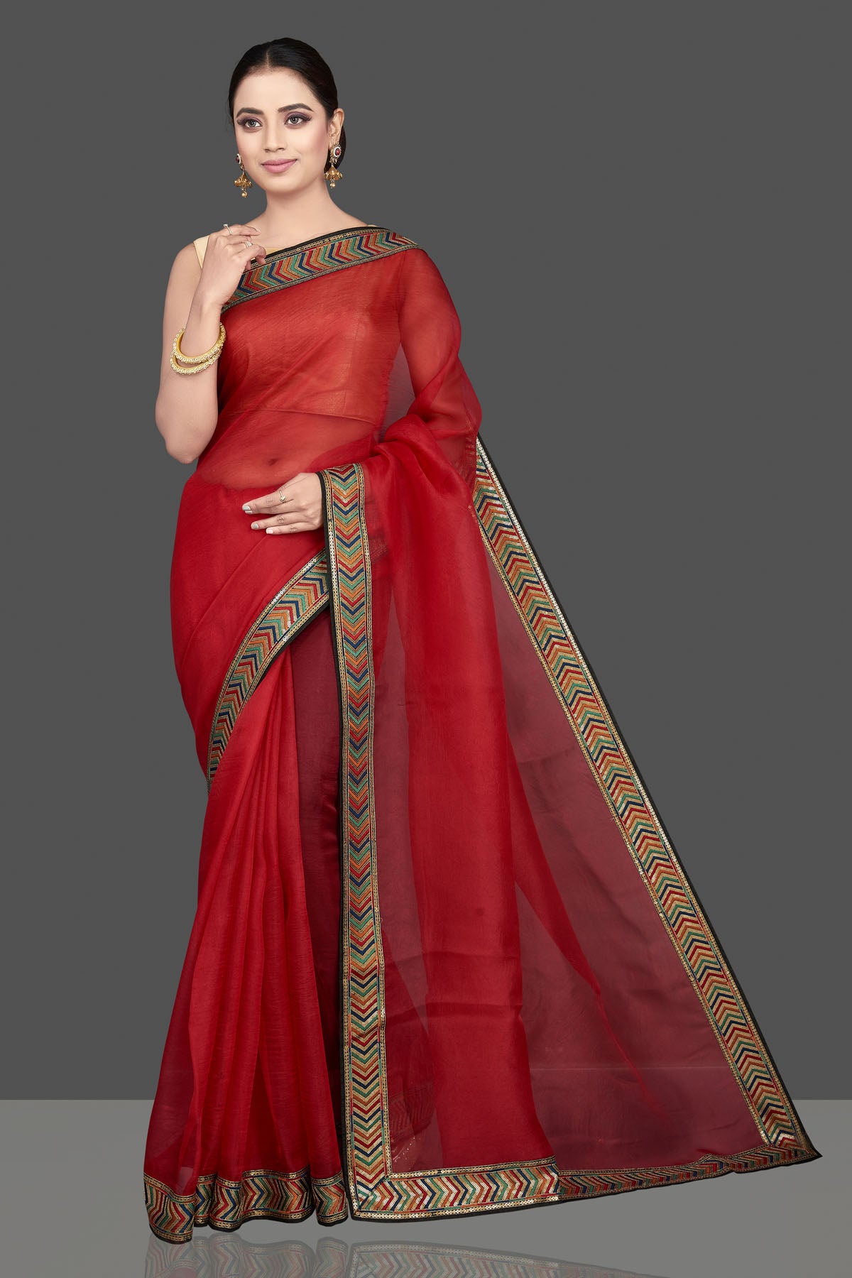 Shop gorgeous red organza saree online in USA with golden border. Look attractive on weddings and parties in beautiful designer sarees, pure silk sarees, handwoven saris, embroidered sarees, zari work sarees from Pure Elegance Indian saree store in USA.-full view