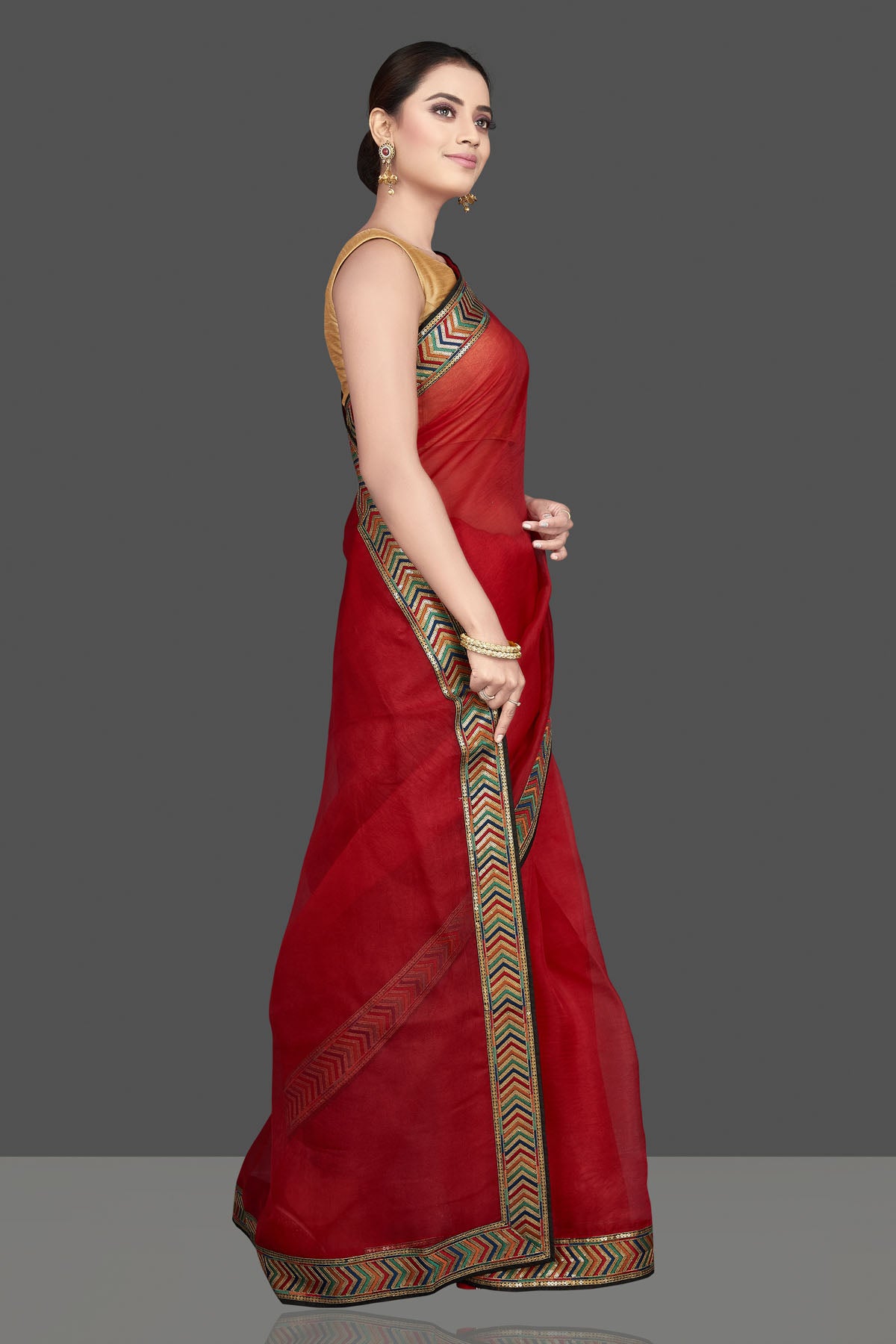 Shop gorgeous red organza saree online in USA with golden border. Look attractive on weddings and parties in beautiful designer sarees, pure silk sarees, handwoven saris, embroidered sarees, zari work sarees from Pure Elegance Indian saree store in USA.-side