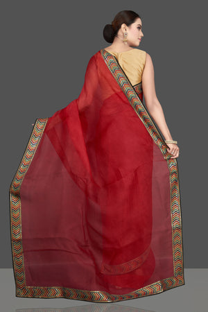 Shop gorgeous red organza saree online in USA with golden border. Look attractive on weddings and parties in beautiful designer sarees, pure silk sarees, handwoven saris, embroidered sarees, zari work sarees from Pure Elegance Indian saree store in USA.-back
