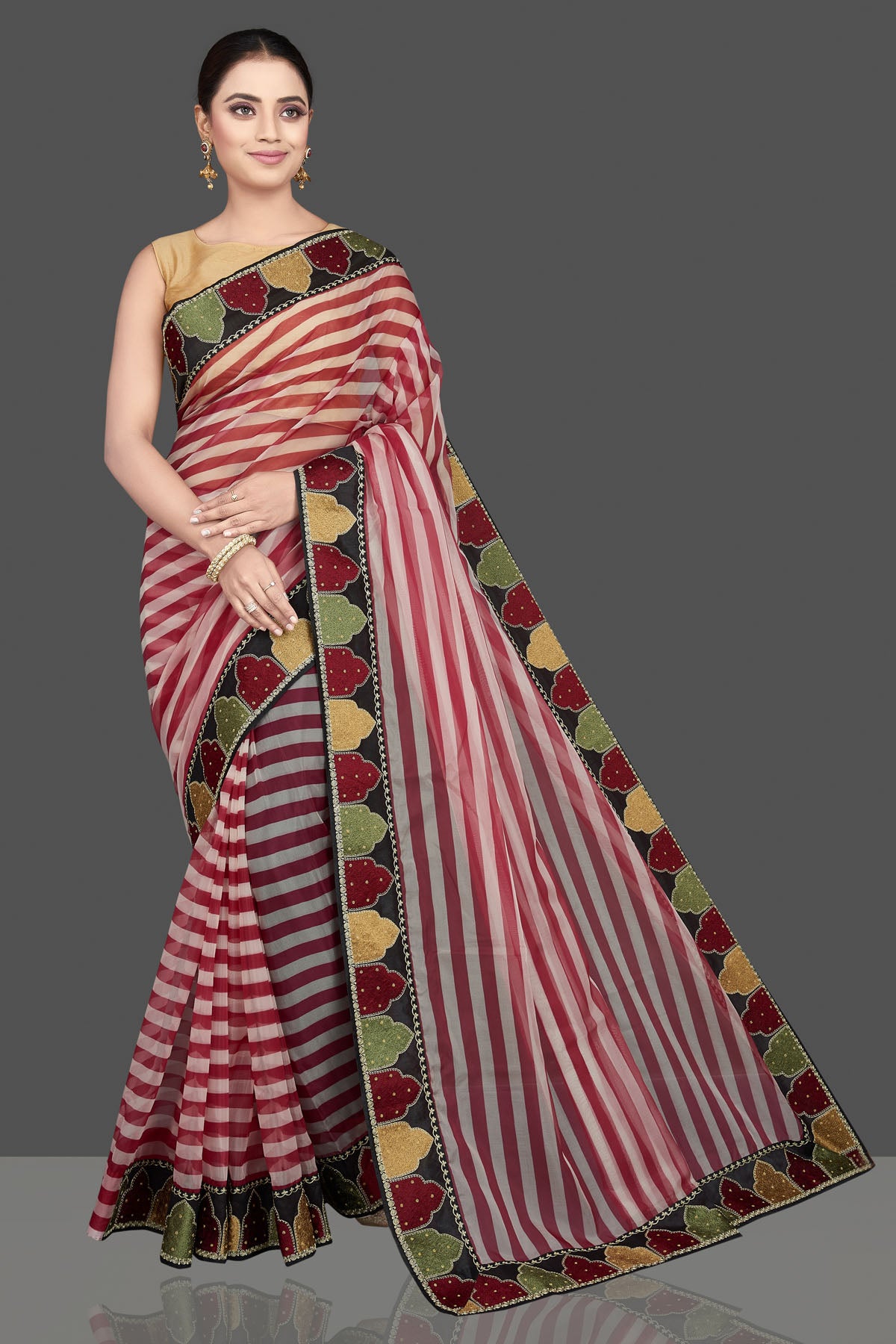 Buy beautiful red and cream organza saree online in USA with embroidered border. Look attractive on weddings and parties in beautiful designer sarees, pure silk sarees, handwoven sarees, embroidered sarees, zari work sarees from Pure Elegance Indian saree store in USA.-full view