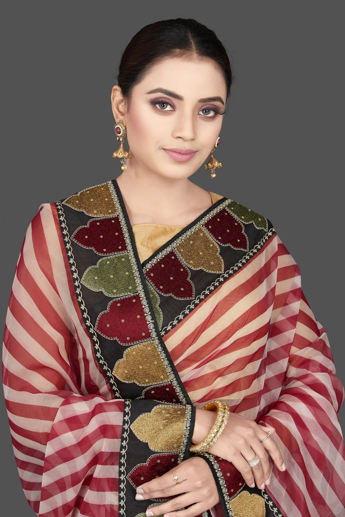 Buy beautiful red and cream organza saree online in USA with embroidered border. Look attractive on weddings and parties in beautiful designer sarees, pure silk sarees, handwoven sarees, embroidered sarees, zari work sarees from Pure Elegance Indian saree store in USA.-closeup