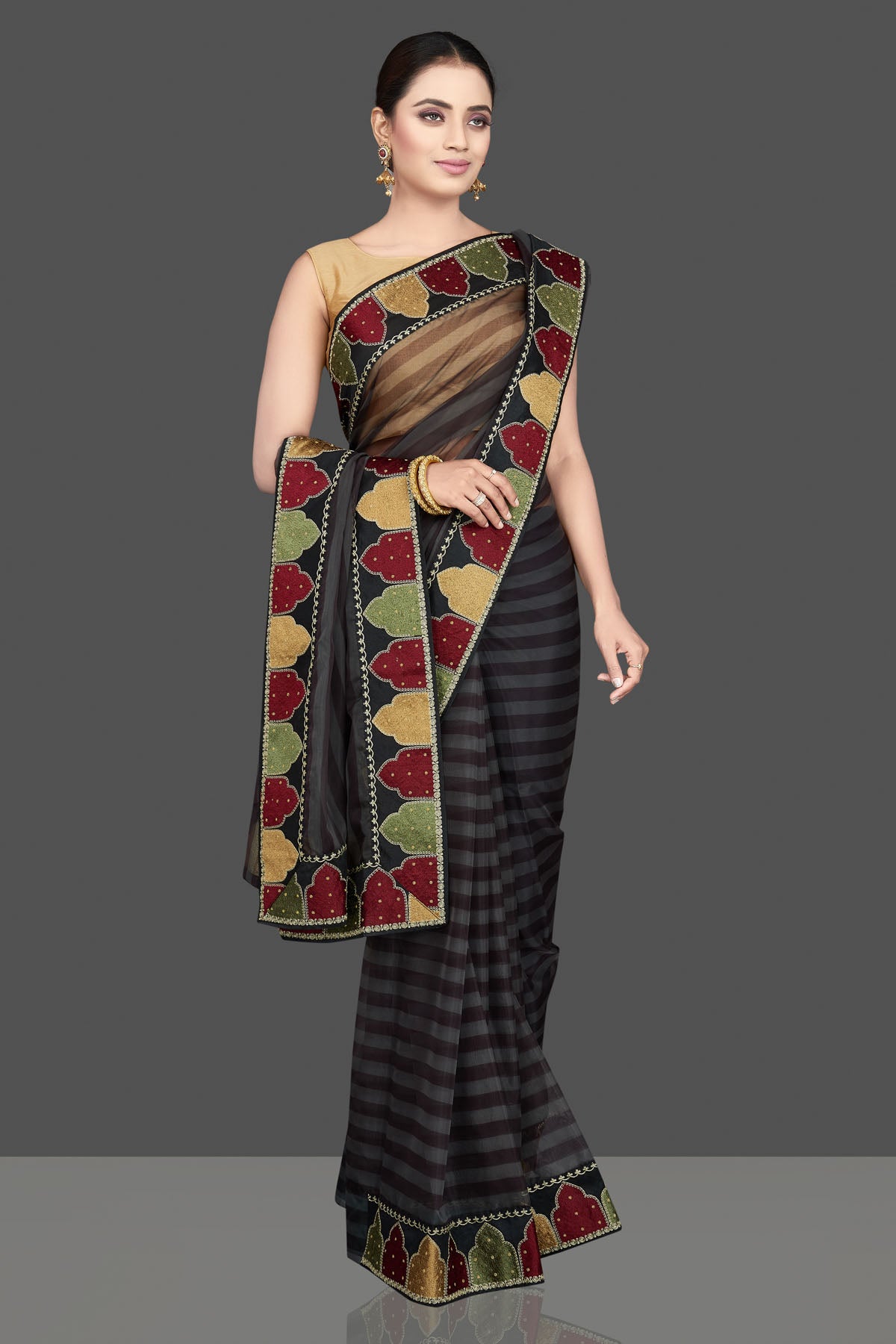 Buy gorgeous grey and black organza silk saree online in USA with designer border. Look attractive on weddings and parties in beautiful designer sarees, pure silk sarees, handwoven sarees, embroidered sarees, zari work sarees from Pure Elegance Indian saree store in USA.-front