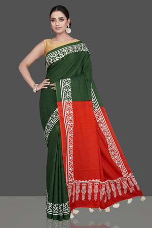 Buy gorgeous red and green modal silk saree online in USA with white print border. Be the highlight of the occasion in beautiful pure silk saree, designer saris, handloom sarees, embroidered sarees, Kanchipuram sarees, Banarasi saris from Pure Elegance Indian saree store in USA.-front