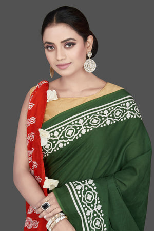 Buy gorgeous red and green modal silk saree online in USA with white print border. Be the highlight of the occasion in beautiful pure silk saree, designer saris, handloom sarees, embroidered sarees, Kanchipuram sarees, Banarasi saris from Pure Elegance Indian saree store in USA.-closeup