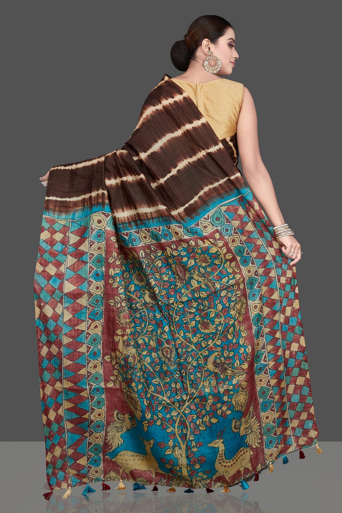 Buy stunning brown tussar silk saree online in USA with pen Kalamkari pallu. Flaunt ethnic fashion on special occasions in stunning georgette sarees, designer saris, embroidered sarees, pure silk sarees, Kanchipuram sarees from Pure Elegance Indian fashion store in USA.-back