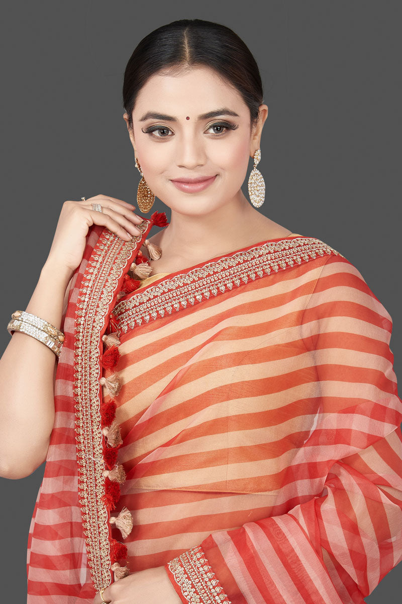 Shop beautiful cream and red striped and embroidered organza saree online in USA. Turn heads on special occasion in stunning handwoven sarees, organza saris, pure silk sarees, Banarasi sarees, embroidered sarees from Pure Elegance Indian saree store in USA.-closeup