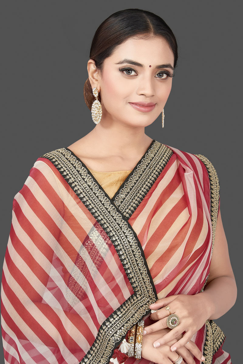 Buy beautiful red and cream striped organza saree online in USA with embroidered border. Turn heads on special occasion in stunning handwoven sarees, organza saris, pure silk sarees, Banarasi sarees, embroidered sarees from Pure Elegance Indian saree store in USA.-closeup