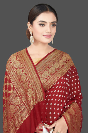 Buy beautiful maroon georgette sari online in USA with zari buta and border. Get your hands on beautiful Indian handloom sarees, pure silk saris, designer sarees, embroidered sarees, Banarasi sarees from Pure Elegance Indian fashion store in USA.-closeup