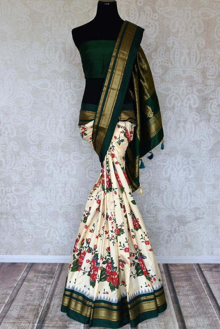 Buy gorgeous cream floral print Gadhwal silk sari online in USA with green zari border. Be the center of attraction at weddings and special occasions in exquisite designer sarees, handwoven silk saris, organza sarees, pure silk saris from Pure Elegance Indian fashion store in USA.-full view