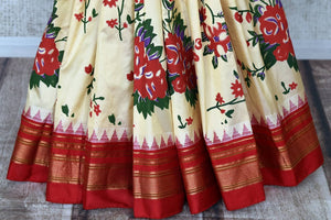 Shop stunning cream floral print Gadhwal silk sari online in USA with red zari border. Be the center of attraction at weddings and special occasions in exquisite designer sarees, handwoven silk saris, organza sarees, pure silk saris from Pure Elegance Indian fashion store in USA.-pleats
