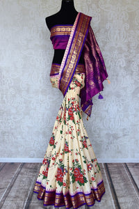 Shop beautiful cream floral print Gadhwal silk saree online in USA with purple zari border. Be the center of attraction at weddings and special occasions in exquisite designer sarees, handwoven silk saris, organza sarees, pure silk saris from Pure Elegance Indian fashion store in USA.-full view