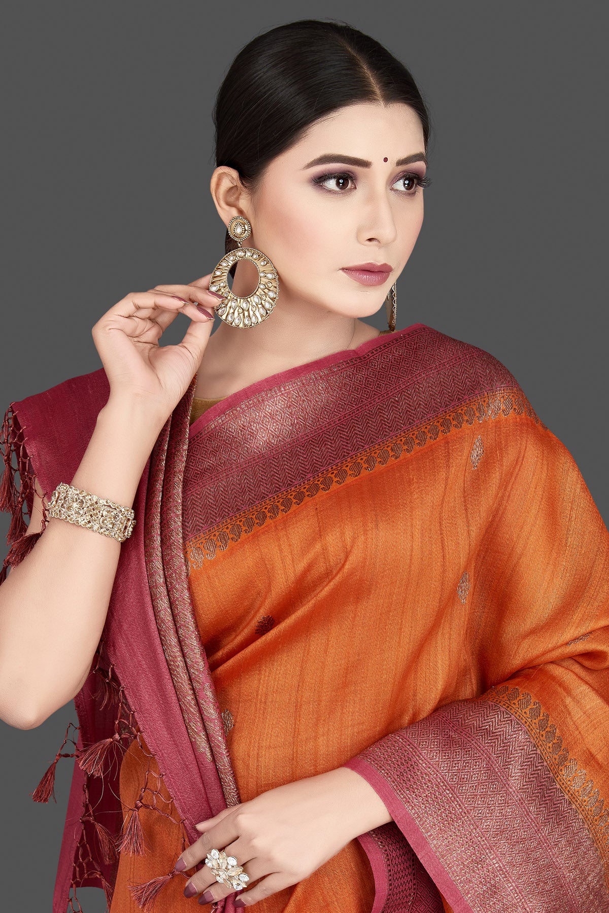 Shop gorgeous rust orange tussar silk saree online in USA with pink antique golden zari border. Be the center of attraction at weddings and special occasions in exquisite designer sarees, handwoven silk saris, embroidered sarees, pure silk sarees from Pure Elegance Indian fashion store in USA.-closeup
