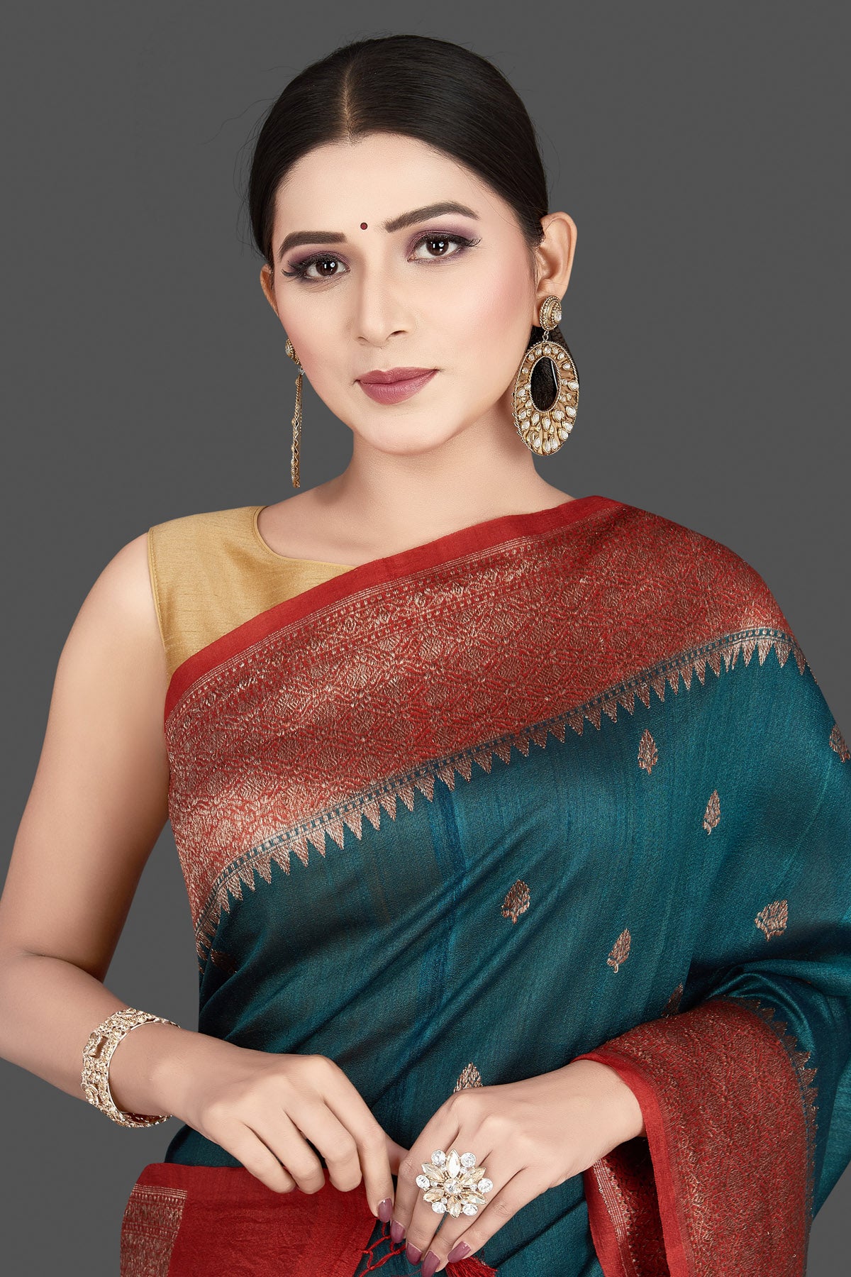 Shop stunning teal green tussar silk saree online in USA with red antique golden zari border. Be the center of attraction at weddings and special occasions in exquisite designer sarees, handwoven silk saris, embroidered sarees, pure silk sarees from Pure Elegance Indian fashion store in USA.-closeup