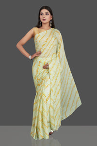 Shop stunning light yellow bandhani print chiffon sari online in USA. Be the center of attraction at weddings and special occasions in exquisite designer sarees, handwoven silk saris, embroidered sarees, pure silk sarees from Pure Elegance Indian fashion store in USA.-full view