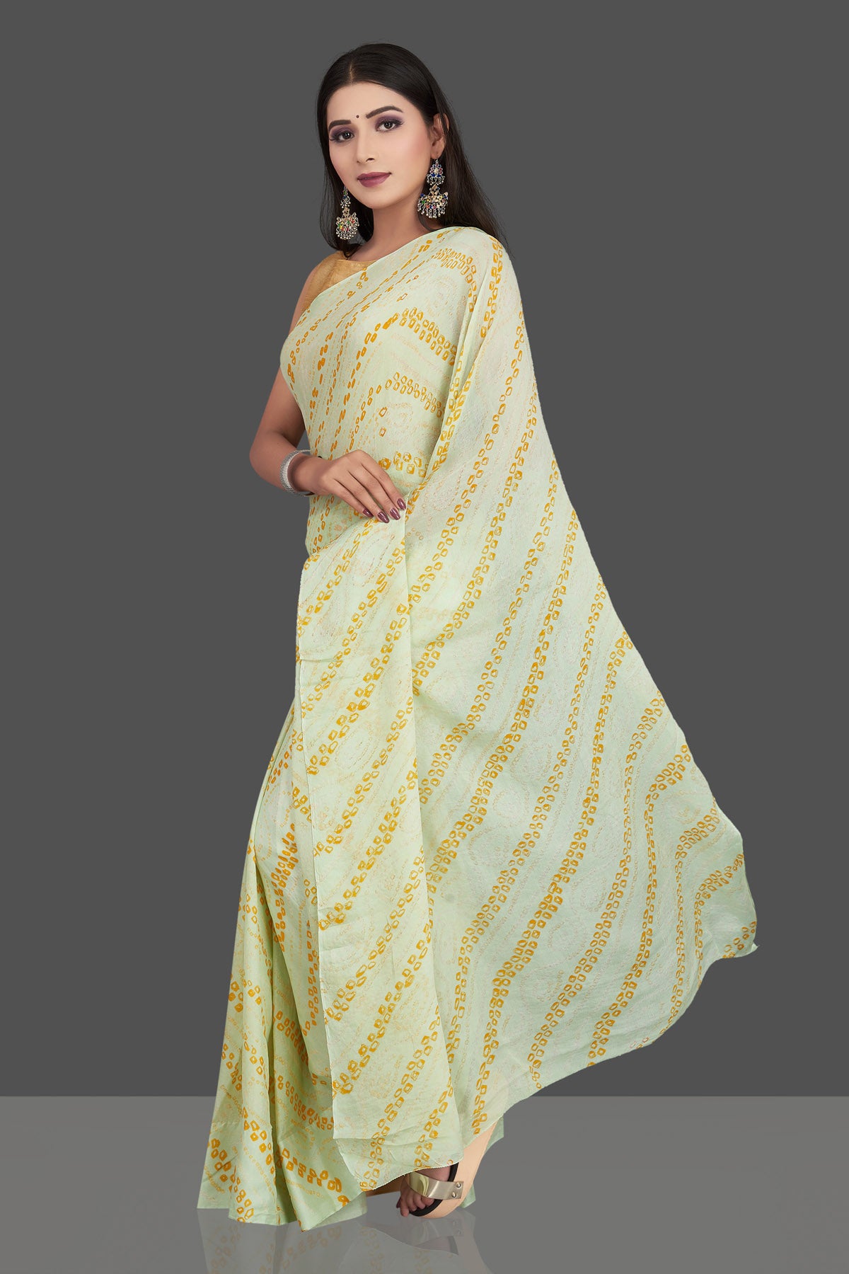 Shop stunning light yellow bandhani print chiffon sari online in USA. Be the center of attraction at weddings and special occasions in exquisite designer sarees, handwoven silk saris, embroidered sarees, pure silk sarees from Pure Elegance Indian fashion store in USA.-pallu