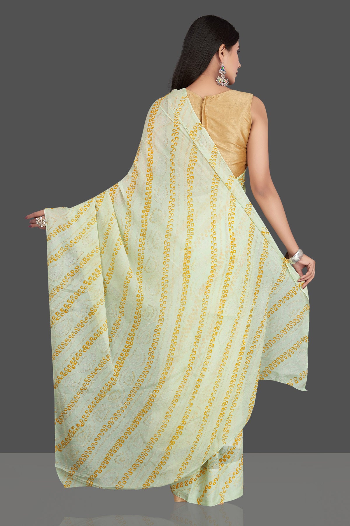 Shop stunning light yellow bandhani print chiffon sari online in USA. Be the center of attraction at weddings and special occasions in exquisite designer sarees, handwoven silk saris, embroidered sarees, pure silk sarees from Pure Elegance Indian fashion store in USA.-back
