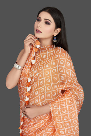 Shop stunning peach printed organza silk saree online in USA. Be the center of attraction at weddings and special occasions in exquisite designer sarees, handwoven silk sarees, embroidered saris, pure silk saris from Pure Elegance Indian fashion store in USA.-closeup