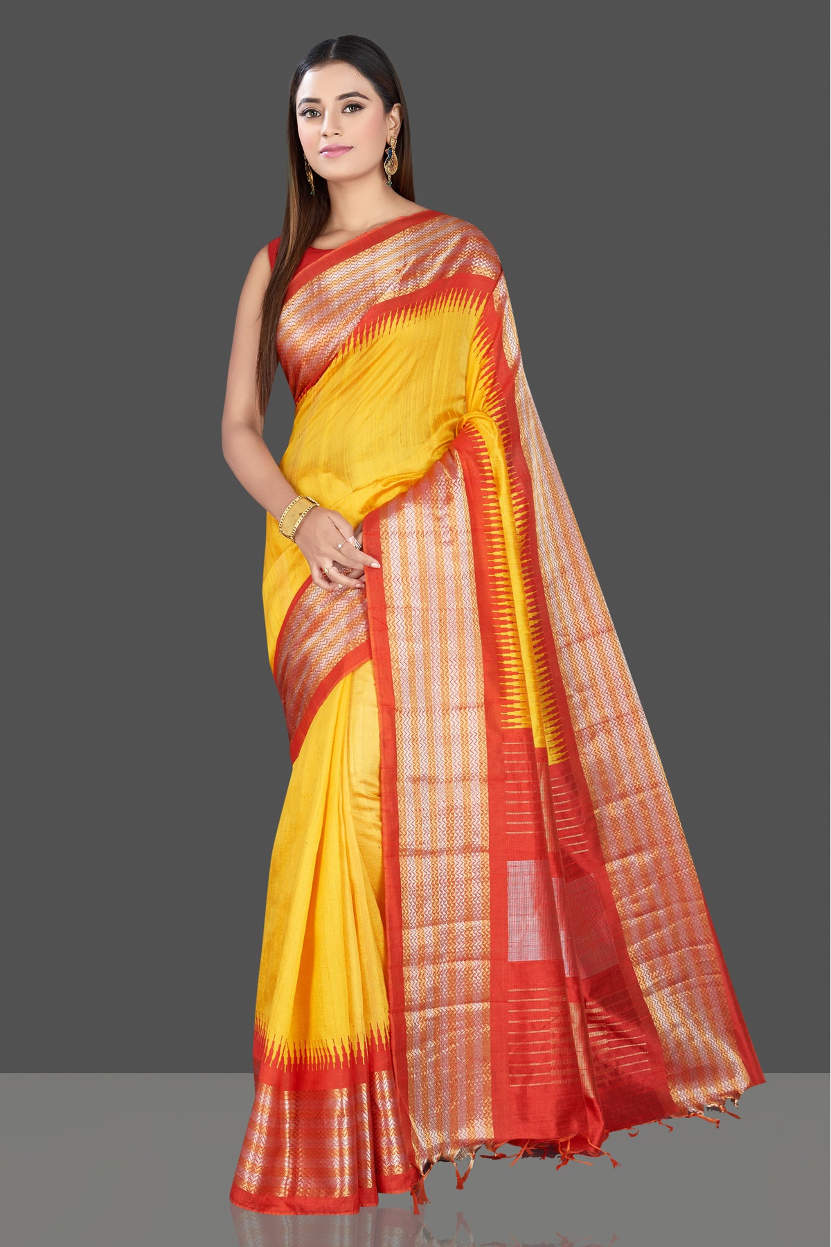 Shop gorgeous yellow silk saree online in USA with red tissue zari border. Look traditional on special occasions and weddings in gorgeous silk sarees, Kanjivaram sarees, south silk sarees, handloom silk sarees from Pure Elegance Indian saree store in USA.-front