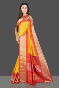 Shop gorgeous yellow silk saree online in USA with red tissue zari border. Look traditional on special occasions and weddings in gorgeous silk sarees, Kanjivaram sarees, south silk sarees, handloom silk sarees from Pure Elegance Indian saree store in USA.-full view