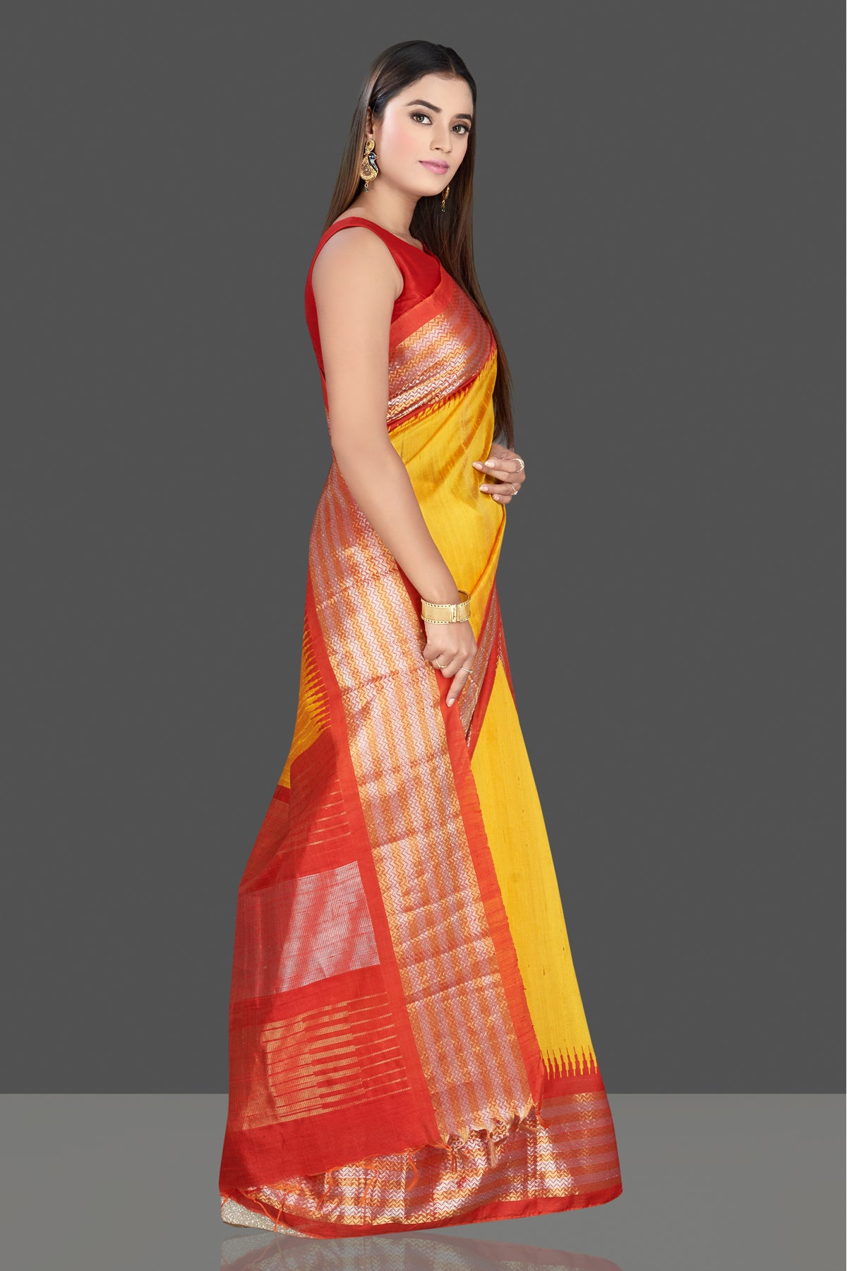 Shop gorgeous yellow silk saree online in USA with red tissue zari border. Look traditional on special occasions and weddings in gorgeous silk sarees, Kanjivaram sarees, south silk sarees, handloom silk sarees from Pure Elegance Indian saree store in USA.-right