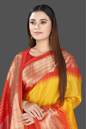 Shop gorgeous yellow silk saree online in USA with red tissue zari border. Look traditional on special occasions and weddings in gorgeous silk sarees, Kanjivaram sarees, south silk sarees, handloom silk sarees from Pure Elegance Indian saree store in USA.-closeup