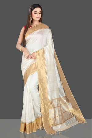 Buy beautiful cream silk saree online in USA with golden temple zari border. Look traditional on special occasions and weddings in gorgeous silk sarees, Kanjivaram sarees, south silk sarees, handloom silk sarees from Pure Elegance Indian saree store in USA.-front
