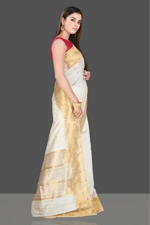 Buy beautiful cream silk saree online in USA with golden temple zari border. Look traditional on special occasions and weddings in gorgeous silk sarees, Kanjivaram sarees, south silk sarees, handloom silk sarees from Pure Elegance Indian saree store in USA.-right