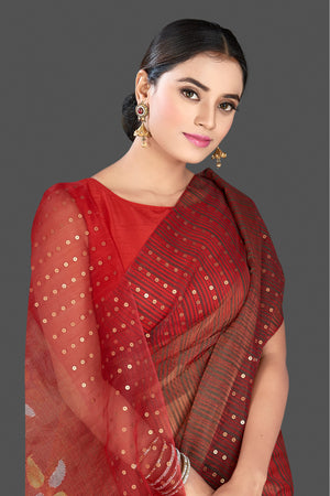 Shop stunning maroon muslin Jamdani saree online in USA with sequin border. Radiate traditional elegance on festive occasions in beautiful handloom silk sarees, paithani sarees, Lucknowi sarees, embroidered sarees from Pure Elegance Indian saree store in USA.-closeup