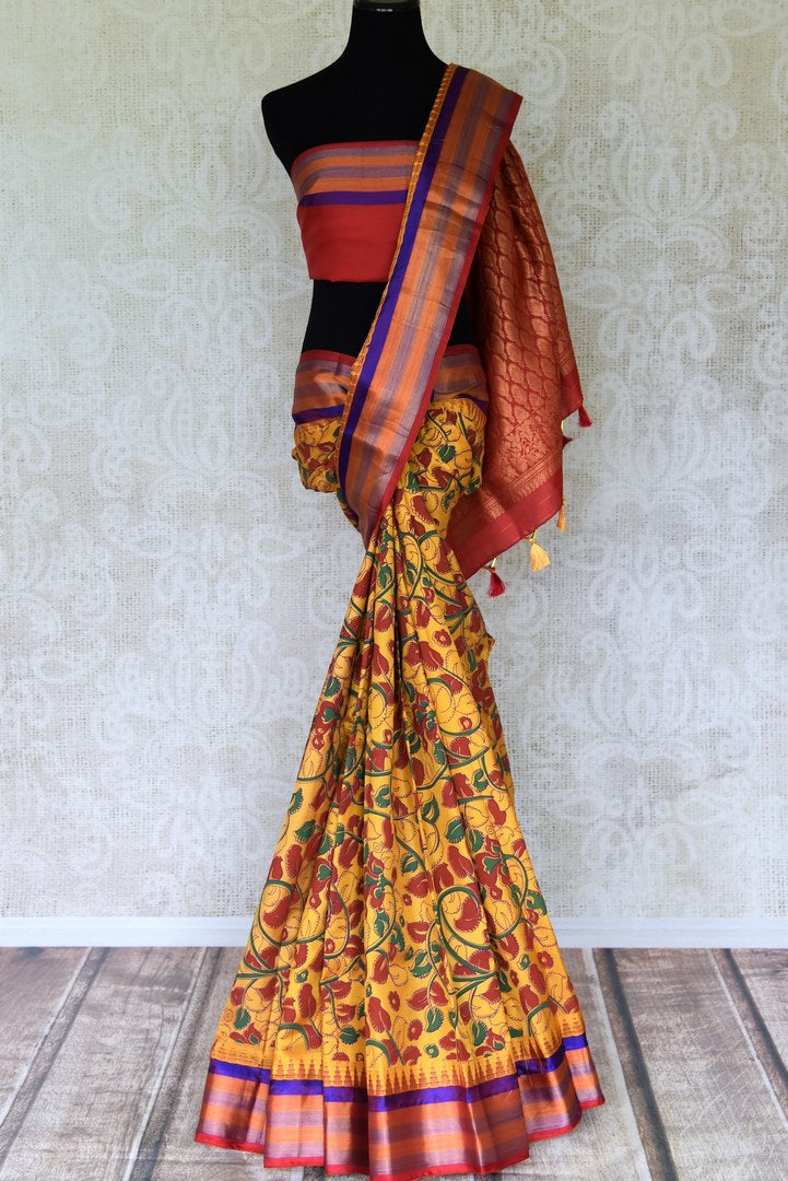 Buy beautiful mustard floral print Gadhwal silk saree online in USA with multicolor border. Be the center of attraction at parties and weddings in exclusive Kanchipuram silk sarees, pure silk sarees, handloom silk sarees, Banarasi silk sarees from Pure Elegance Indian fashion store in USA.-full view