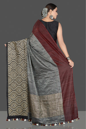 Buy beautiful grey tussar raw silk sari online in USA with black zari border. Keep your Indian wardrobe update with exclusive designer sarees, pure silk sarees, handloom silk sarees, Banarasi sarees from Pure Elegance Indian fashion store in USA.-back