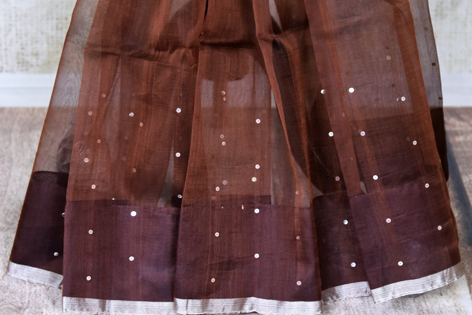 Shop gorgeous brown muslin matka silk sari online in USA with silver aanchal. Be the center of attraction on special occasions in beautiful handloom sarees, matka silk sarees, pure silk saris, Kanchipuram silk sarees, south silk sarees from Pure Elegance Indian saree store in USA.-pleats