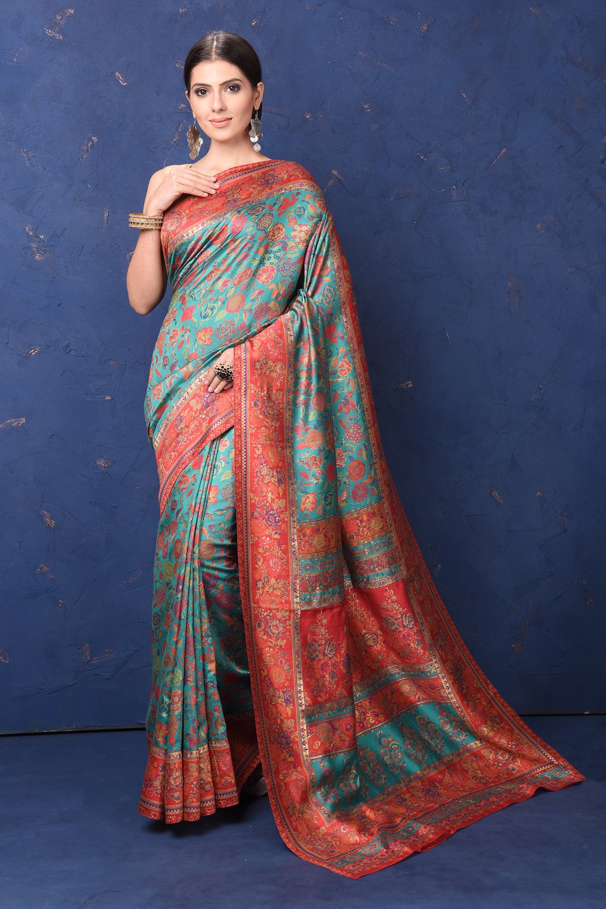 Shop stunning blue Kani weave saree online in USA with red border. Buy latest designer sarees, handloom saris, embroidered sarees, Bollywood sarees, fancy sarees for special occasions from Pure Elegance Indian fashion store in USA. Shop soft silk sarees, pure Banarasi sarees, cotton sarees, georgette sarees. -full view