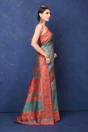 Shop stunning blue Kani weave saree online in USA with red border. Buy latest designer sarees, handloom saris, embroidered sarees, Bollywood sarees, fancy sarees for special occasions from Pure Elegance Indian fashion store in USA. Shop soft silk sarees, pure Banarasi sarees, cotton sarees, georgette sarees. -side
