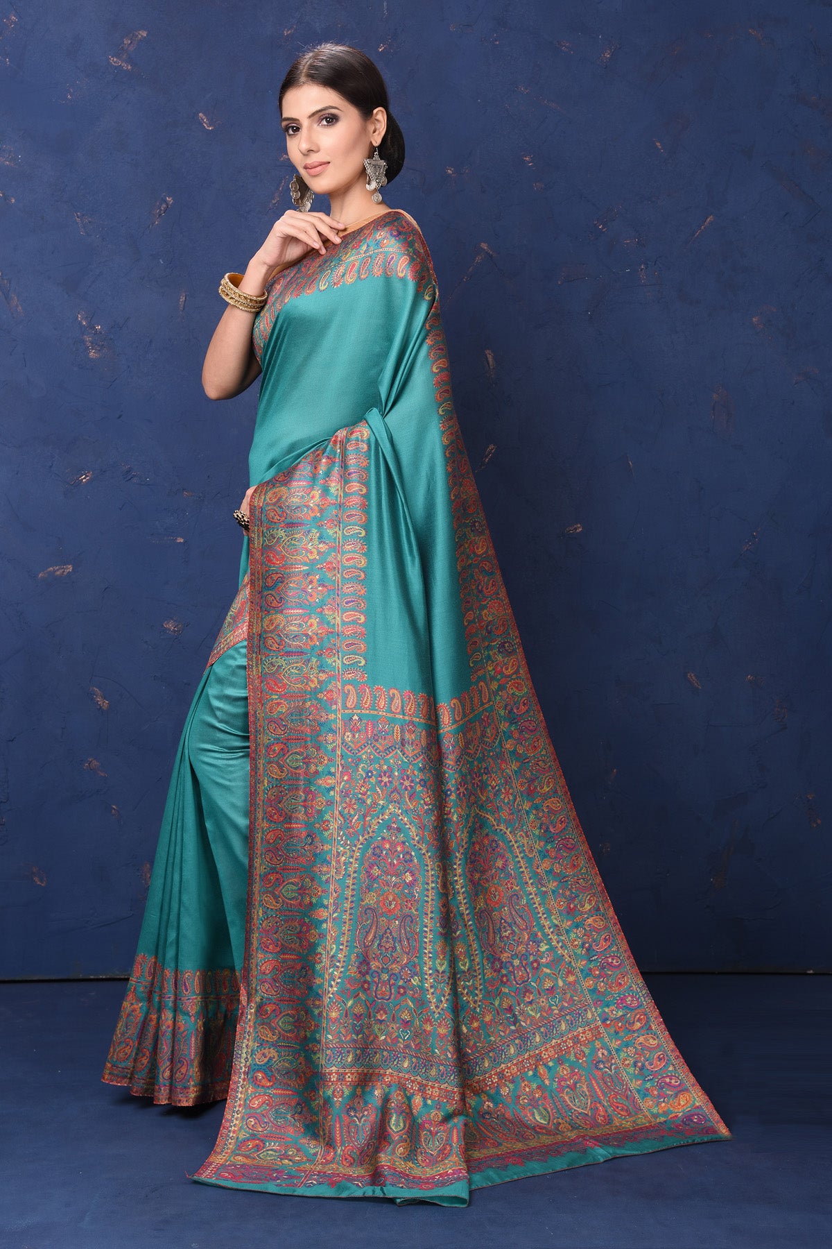 Shop stunning blue tussar muga silk sari online in USA with Kani border. Buy latest designer sarees, handloom saris, embroidered sarees, Bollywood sarees, fancy sarees for special occasions from Pure Elegance Indian fashion store in USA. Shop soft silk sarees, pure Banarasi sarees, cotton sarees, georgette sarees. -side