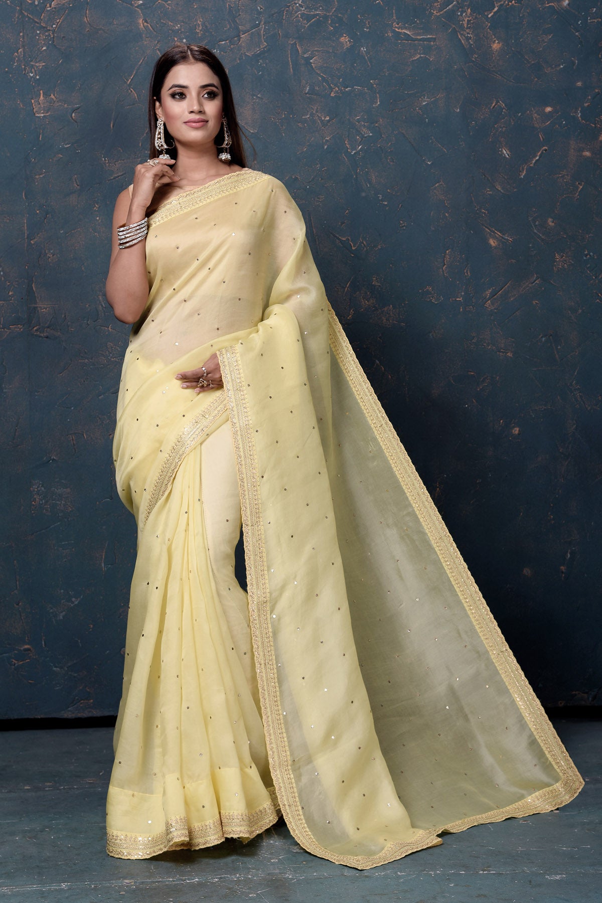 Buy beautiful light yellow organza saree online in USA with embroidered border. Enrich your ethnic wardrobe with traditional Indian sarees, designer sarees. embroidered sarees, pure silk sarees, handwoven sarees, Kanchipuram sarees, Banarasi saris from Pure Elegance Indian saree store in USA.-full view