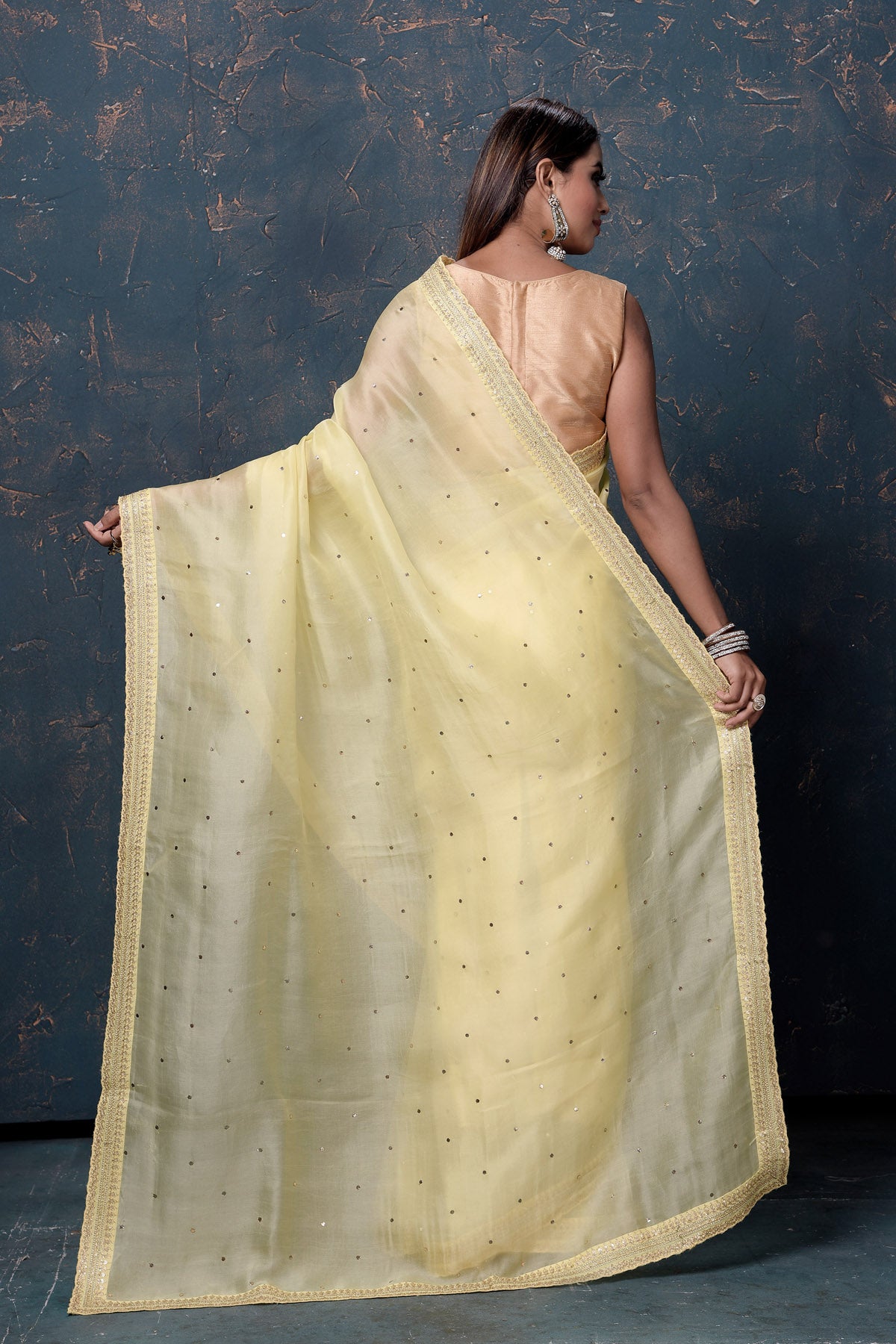 Buy beautiful light yellow organza saree online in USA with embroidered border. Enrich your ethnic wardrobe with traditional Indian sarees, designer sarees. embroidered sarees, pure silk sarees, handwoven sarees, Kanchipuram sarees, Banarasi saris from Pure Elegance Indian saree store in USA.-back