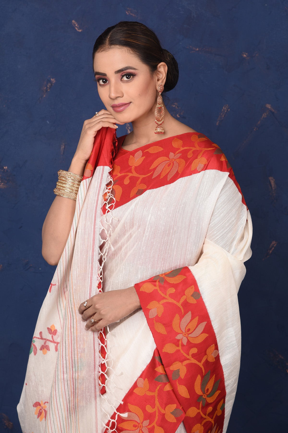 Buy beautiful off-white matka silk saree online in USA with red cut shuttle weave border. Look elegant on festive occasions in exclusive silk sarees, matka sarees, handwoven sarees, embroidered sarees, designer sarees from Pure Elegance Indian saree store in USA.-closeup