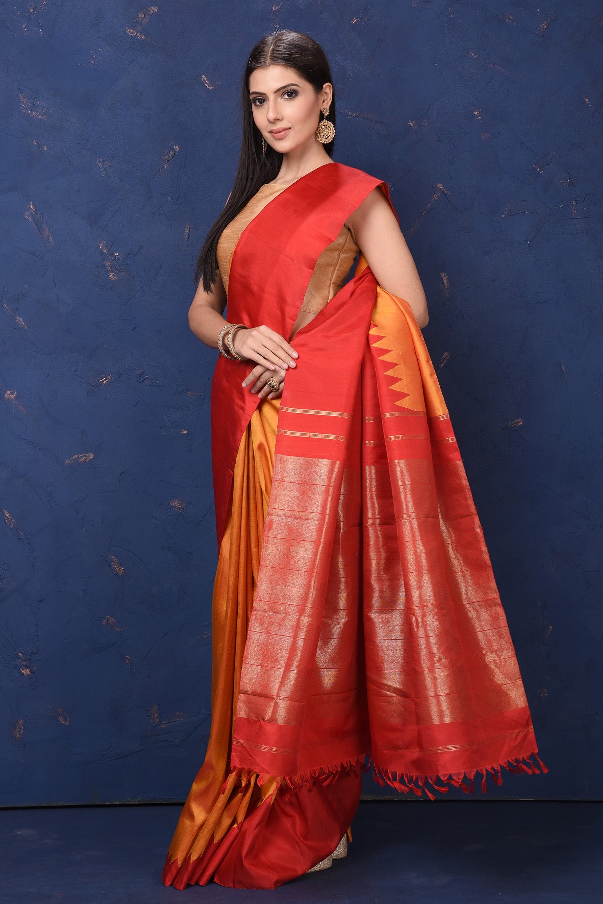 Buy beautiful orange Kanjivaram silk saree online in USA with red temple border. Flaunt your ethnic style at weddings and festive occasions in exquisite Indian sarees, Kanjeevaram sarees, handloom sarees, designer sarees, embroidered sarees from Pure Elegance Indian saree store in USA.-side