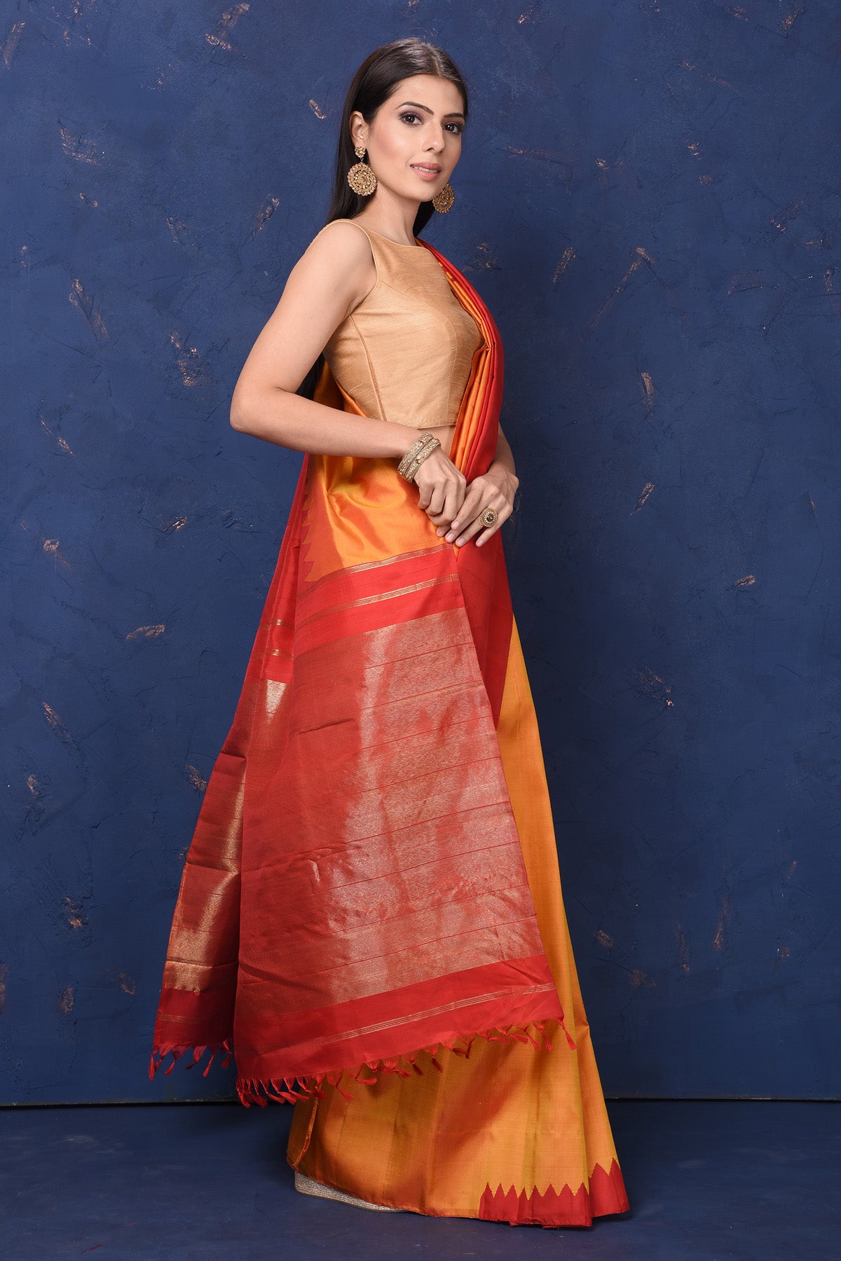 Buy beautiful orange Kanjivaram silk saree online in USA with red temple border. Flaunt your ethnic style at weddings and festive occasions in exquisite Indian sarees, Kanjeevaram sarees, handloom sarees, designer sarees, embroidered sarees from Pure Elegance Indian saree store in USA.-right
