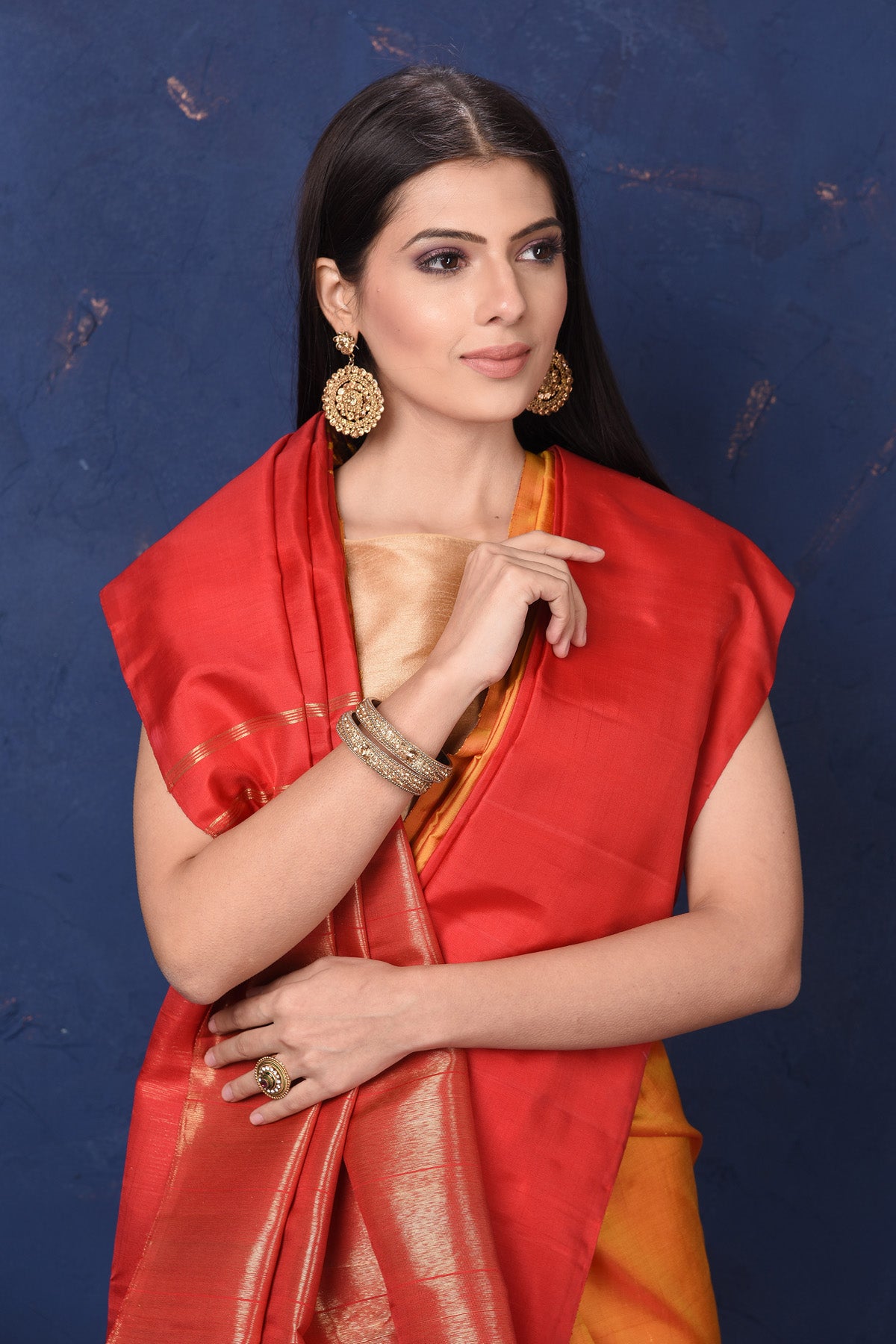 Buy beautiful orange Kanjivaram silk saree online in USA with red temple border. Flaunt your ethnic style at weddings and festive occasions in exquisite Indian sarees, Kanjeevaram sarees, handloom sarees, designer sarees, embroidered sarees from Pure Elegance Indian saree store in USA.-closeup