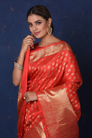 Buy stunning red Kanjeevaram sari online in USA with golden zari buta and zari border. Be the center of attraction on special occasions in stunning designer sarees, handloom sarees, Kanchipuram silk sarees, pure silk sarees from Pure Elegance Indian fashion store in USA.-closeup