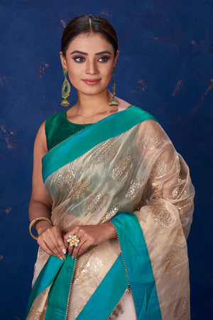 Shop stunning beige foil print organza saree online in USA with green border. Keep your ethnic wardrobe with exclusive designer sarees, handloom sarees, pure silk sarees, soft silk sarees, Banarasi silk sarees from Pure Elegance Indian fashion store in USA.-closeup